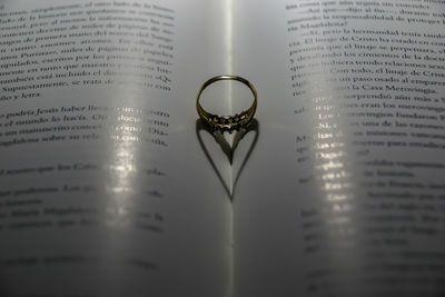 Close-up of wedding rings on book