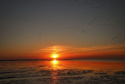 Scenic view of sea against sky at sunset