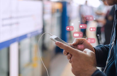 Midsection of man using mobile phone