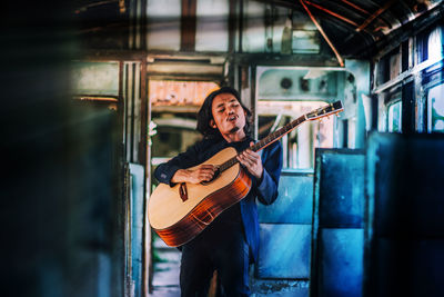 Portrait of man playing guitar