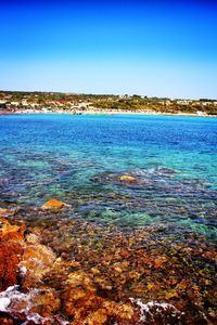 Scenic view of sea against blue sky