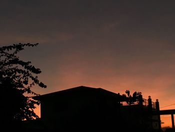 Low angle view of silhouette trees against sky at sunset