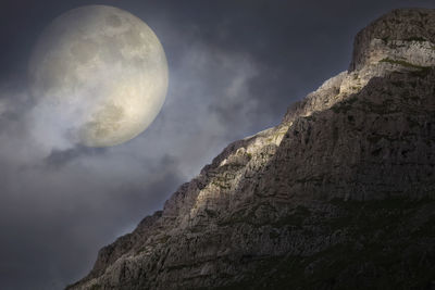 Low angle view of moon against sky at night