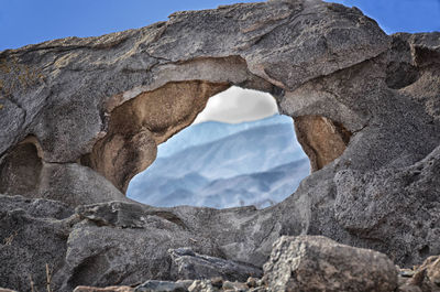 Low angle view of rock formation against sky