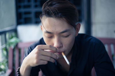 Young man smoking cigarette