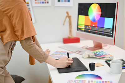 Midsection of man working in office