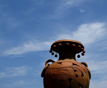 Low angle view of statue against blue sky