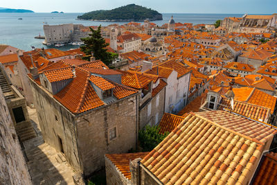 High angle view of townscape by sea against sky