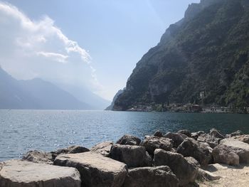 Scenic view of sea and mountains against sky