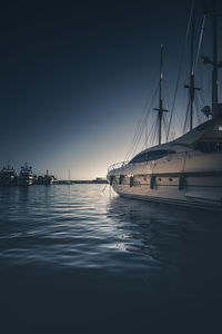 Sailboats in marina at sunset