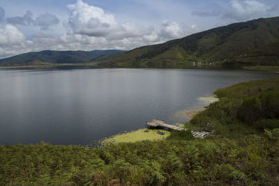 Scenic view of lake and mountains against sky