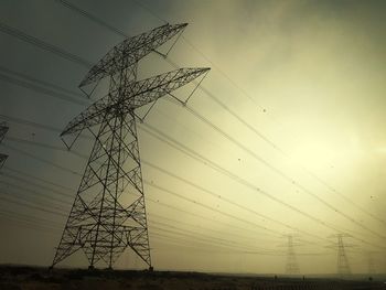 Low angle view of electricity pylon against sky