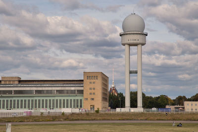View of buildings against cloudy sky at the tempelhof air field in berlin, germany
