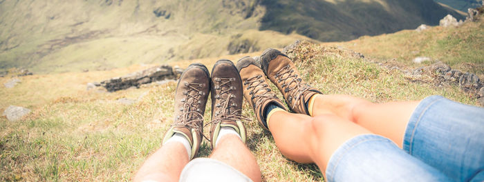 Low section of man and woman lying on land