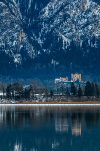 Reflection of buildings in lake during winter