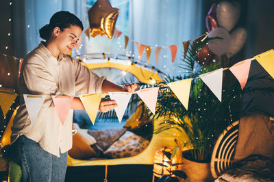 Low angle view of woman holding umbrella