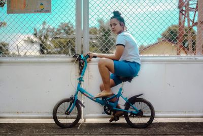 Full length of boy sitting on bicycle