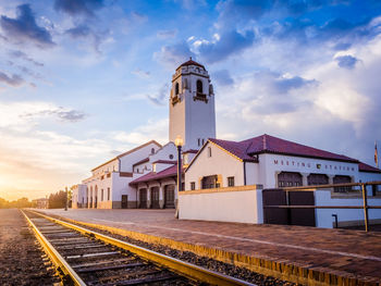 Railroad station against sky in city