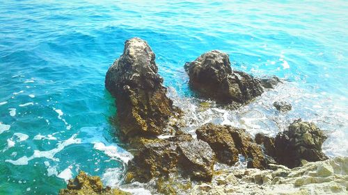 High angle view of rocks in sea