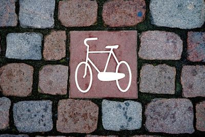 High angle view of bicycle lane sign on footpath