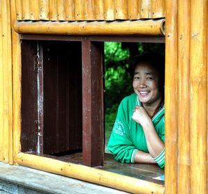 Portrait of smiling boy on window