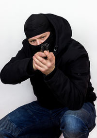 Man wearing mask against white background