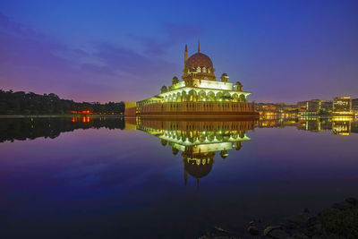 Reflection of illuminated building in lake