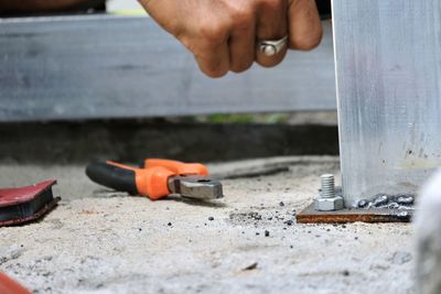 Midsection of person working on barbecue grill