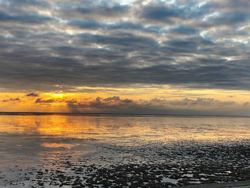 Scenic view of sea against orange sky