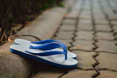 High angle view of shoes on footpath