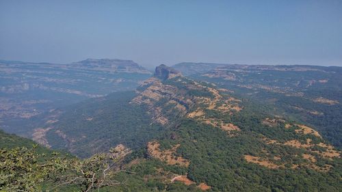 High angle view of land and mountains against sky