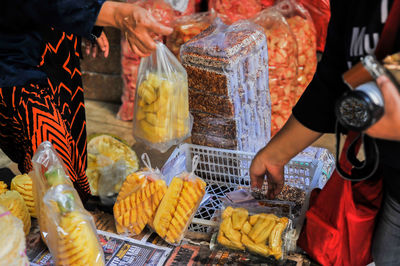 Midsection of man preparing food for sale