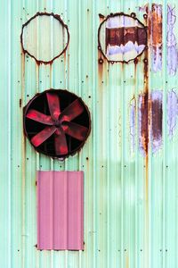 Exhaust fan on rusty metallic wall