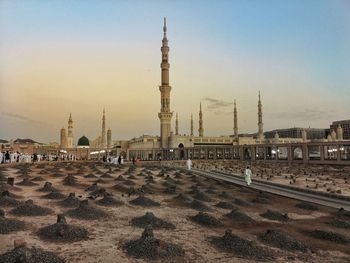 View of mosque against clear sky in city during sunset