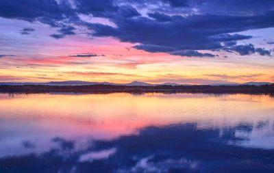 Scenic view of lake against romantic sky at sunset