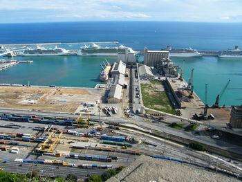 High angle view of cityscape by sea against sky