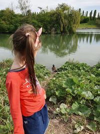 Rear view of woman against lake