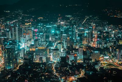 High angle view of illuminated city buildings at night