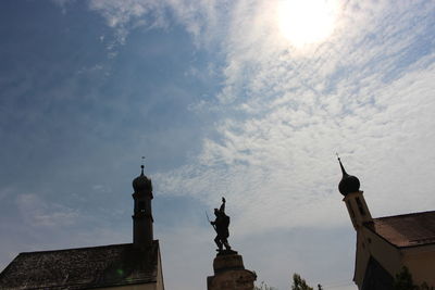 Low angle view of statue of historic building against sky