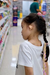 Cute girl looking away at store
