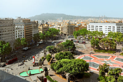 High angle view of trees and buildings in city