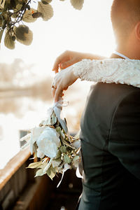 Midsection of woman holding white flower