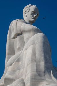 Low angle view of statue against blue sky
