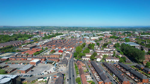 High angle view of townscape against clear blue sky. main road running through the centre with cars.