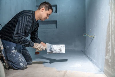 Side view of man working at home