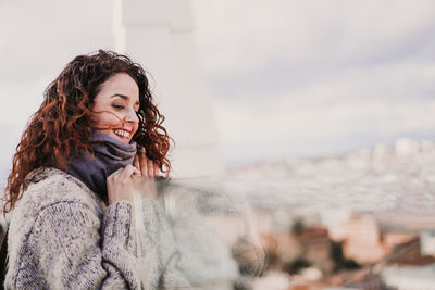 Young woman looking at snow during winter