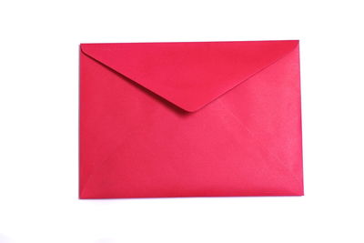 Close-up of red paper over white background