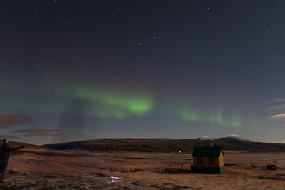 Scenic view of land against sky at night