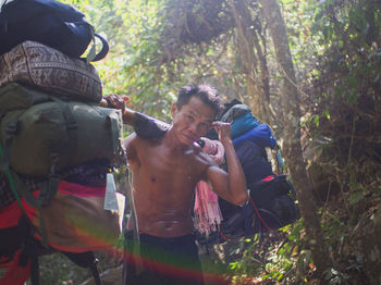 Man holding camera in forest