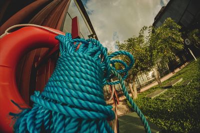 Close-up of rope tied up against blue sky